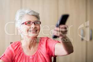 Senior woman using a remote control
