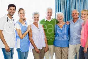 Nurse and seniors standing together