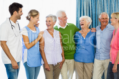 Nurse and seniors standing together