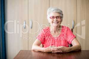 Senior woman sitting at a table