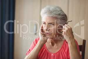 Thoughtful senior woman sitting at a table