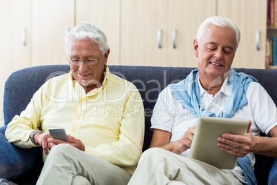 Senior men using technology