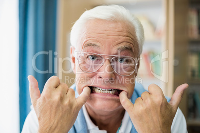 Senior man making faces