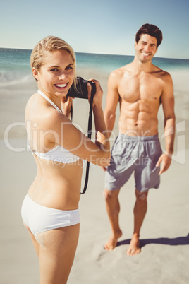 Woman taking picture of her man