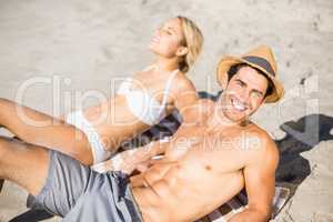 Young couple lying on beach