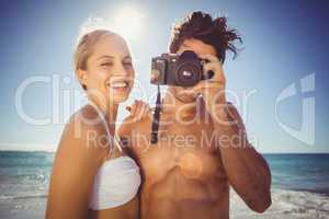 Couple clicking photographs from camera