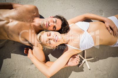 Couple lying on beach