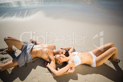 Couple lying on beach