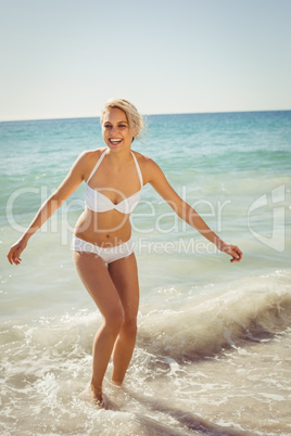 Young woman playing in water