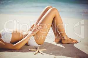 Woman lying on sand alone