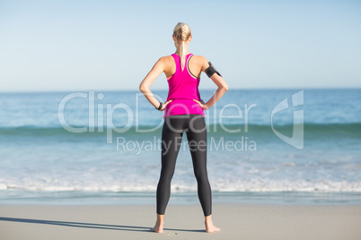 Sportswoman standing on beach