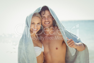 Happy couple covering their heads with towel