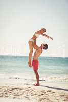 Man lifting woman at beach