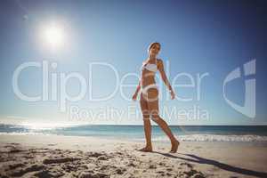 Young woman walking on beach