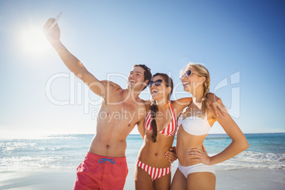 Friends taking selfie on beach