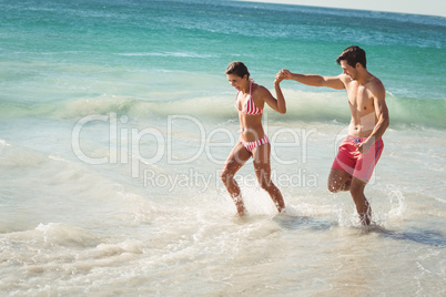 Couple running in water