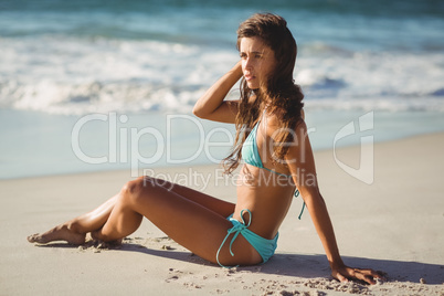 Young woman sitting on beach