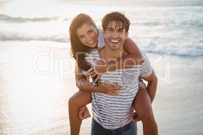 Man giving woman piggyback ride