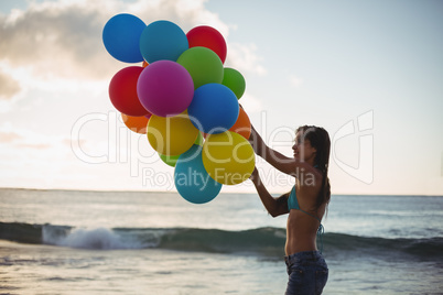 Woman holding colorful balloon