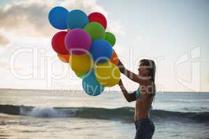 Woman holding colorful balloon