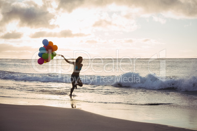 Woman running with the balloon
