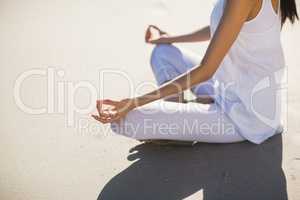 Mid section of woman performing yoga