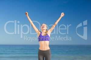 Beautiful young woman smiling while exercising