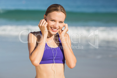 Portrait of beautiful woman listening music while exercising