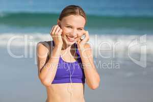 Portrait of beautiful woman listening music while exercising