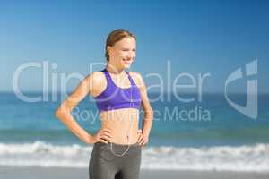 Beautiful young woman listening music while exercising