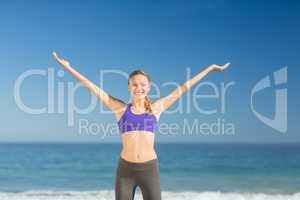 Beautiful young woman smiling while exercising