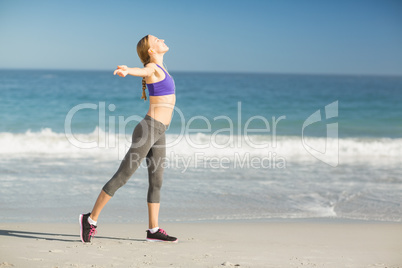 Portrait of beautiful woman listening music while exercising