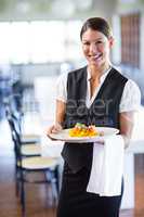 Waitress holding plate in a restaurant