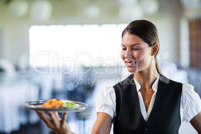 Waitress holding a plate in a restaurant