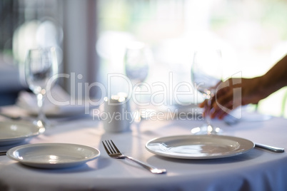 Waitress setting the table