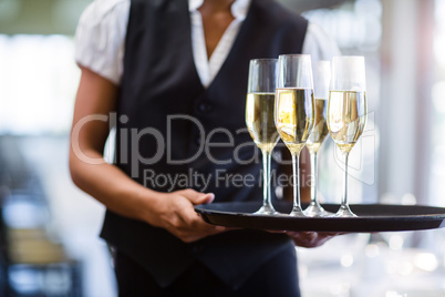 Waitress holding serving tray with champagne flutesÃ?Â 