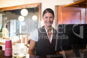 Waitress working on computer at counter