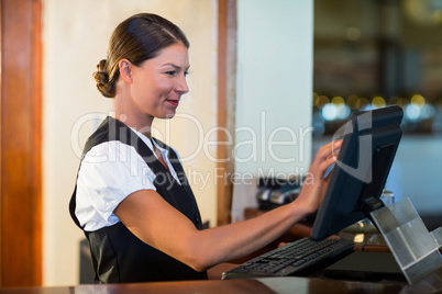 Waitress using a computer at counter