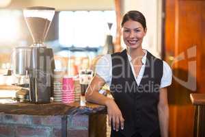 Portrait of waitress standing at counter