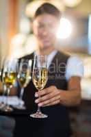 Waitress offering a glass of champagne