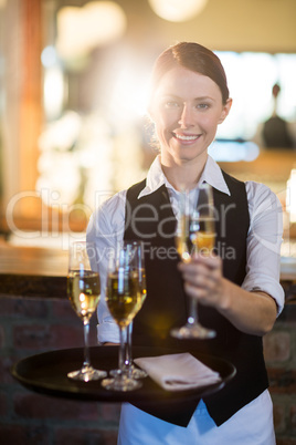 Waitress offering a glass of champagne