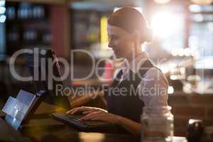 Waitress using a computer at counter