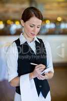 Smiling waitress taking order