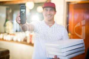Pizza delivery man holding phone