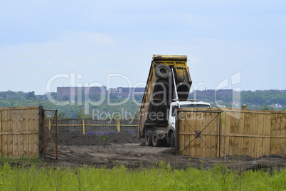 Big old tipper vith clay ground dumped soil in storage space