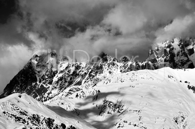 Black and white snowy rocks in haze at sunny day