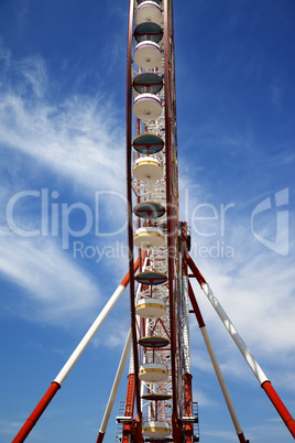 Ferris wheel and blue sky with clouds