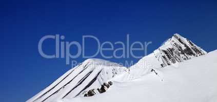 Panoramic view on off-piste slope and blue clear sky in nice day