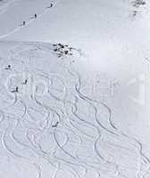 Snowboarder downhill on off piste slope with newly-fallen snow