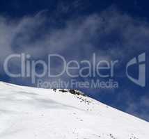 Off-piste slope with stones at windy day